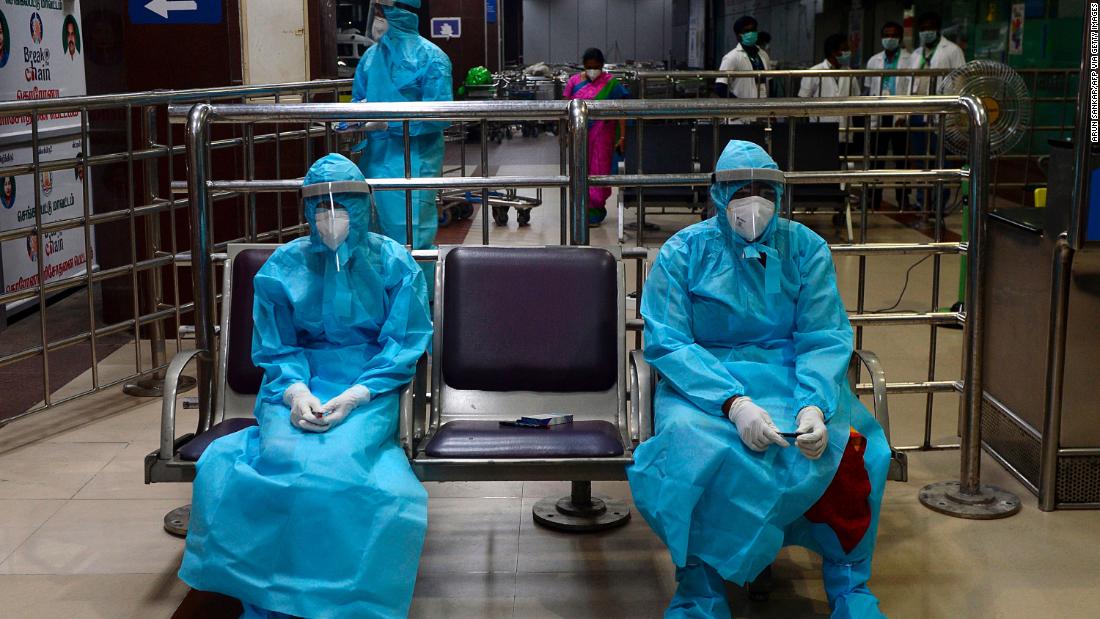 Health-care workers wait for citizens to arrive at the Anna International Airport in Chennai, India, on May 9. People were arriving in Chennai from Dubai, United Arab Emirates.